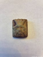 Obverse showing Bes face with headdress, ears and beard