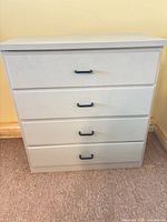 Front view showing four drawers and pulls