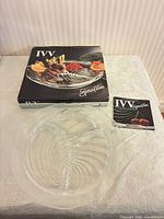 Platter, box, and booklet displayed on table