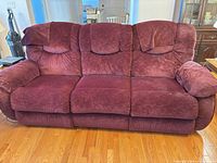 Front view of burgundy La-Z-Boy three-seat reclining sofa