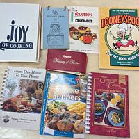 All eight cookbooks laid out; front covers visible
