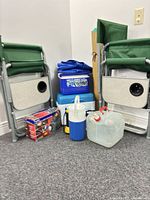 Entire lot showing chairs, coolers, tarp, inflator, water jug, jerry can, flashlight, mat