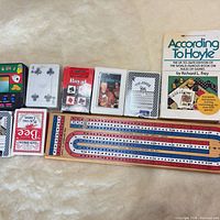 All items: seven card decks, cribbage board, handheld casino game, rule book