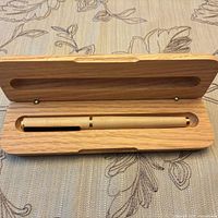 Pen resting in open oak presentation case