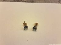 Earrings front view on white background showing stones and posts