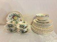 full set stacked with cups, saucers, bowls, plates