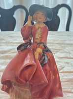 Front view of Royal Doulton figurine showing pose, colors, details