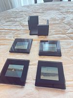 Top view of four glass photo coasters with holder