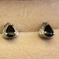 front view of earrings showing onyx centers and diamond accents