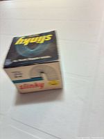 Front angled view of Slinky box showing brand logo