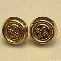 Front view of both earrings showing gold-tone finish and interlaced cross motif
