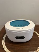 Front view showing ABOX ultrasonic cleaner with lid closed