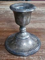 Full view of sterling candlestick showing form and patina