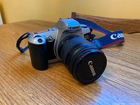 Angled view of camera with lens and strap