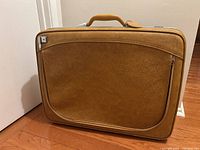 Full view of suitcase front showing color, handle, front pocket