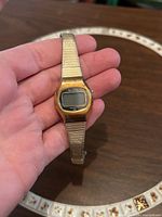 Front view of Bulova digital watch in hand