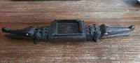 Full view of ebony double-headed crocodile ashtray
