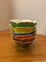 Stacked view showing colour variety and scalloped rims