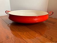 Side profile showing orange exterior and dual handles