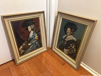 Both framed needlepoint portraits side by side