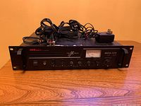 Front view of amplifier with cables and adapter