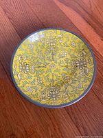 Top view of plate showing full lotus and scroll design and pewter edging