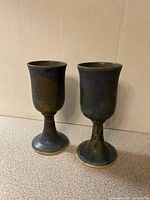 Front view of both glazed pottery goblets standing side by side
