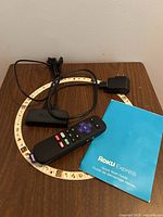 All items laid out: Roku Express player, remote, USB power cable, power adapter, quick start guide