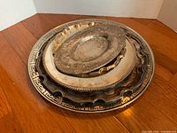 Stack of five assorted silverplate trays