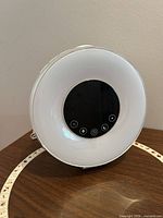 Front view of sunrise alarm clock on stand