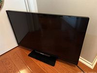 Front view of Philips 32-inch TV on stand
