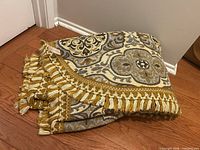 Folded bedspread showing fringe and pattern