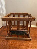 Front view of wooden recycle crate showing plaque