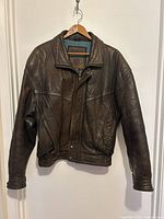 Front view of Midway brown leather jacket hanging
