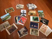 Multiple stacks and loose vintage postcards showing variety of subjects