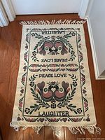 Full view of rug showing design and fringe