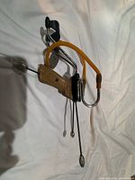 Full view of Barnett Diablo slingshot showing wood grip, metal frame, latex bands and wrist brace
