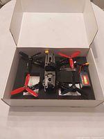 Drone, battery and accessories inside original foam packaging