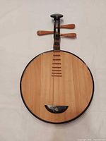 Full view of the yueqin front showing body, neck, missing strings
