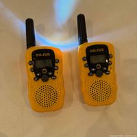 Front view of both Diliss yellow walkie-talkies powered off