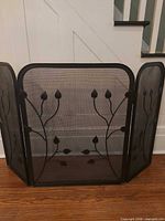 Front view of 3-panel wrought iron fireplace screen fully extended