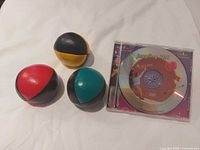 Three two-tone leather juggling balls and Juggling 101 DVD
