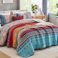Promotional image showing quilt and shams on bed