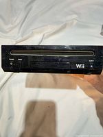 Front view of black Nintendo Wii console horizontal orientation