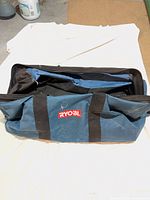 Full view of Ryobi blue canvas tool bag closed