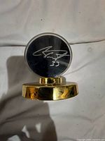 Front view of puck showing silver autograph and number 33