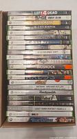 Spines of stacked Xbox 360 game cases in box