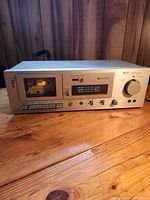 Front angled view of Akai CS-M02 cassette deck on wooden surface