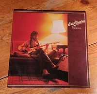 Front cover showing Eric Clapton seated with guitar