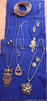 All jewelry pieces laid on blue fabric